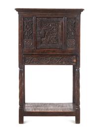 A Gothic Revival Carved Oak Cabinet on Stand