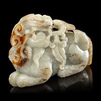 A Chinese Russet and Greyish Celadon Jade Figure of a Recumbent Qilin 青玉麒麟