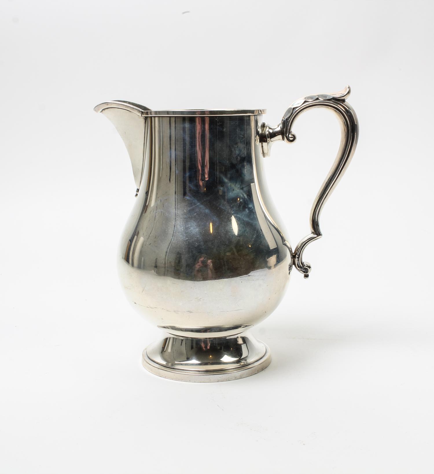 An American Silver Water Pitcher, M. Fred Hirsch Co., Jersey City, NJ, of baluster form, raised on a circular foot.