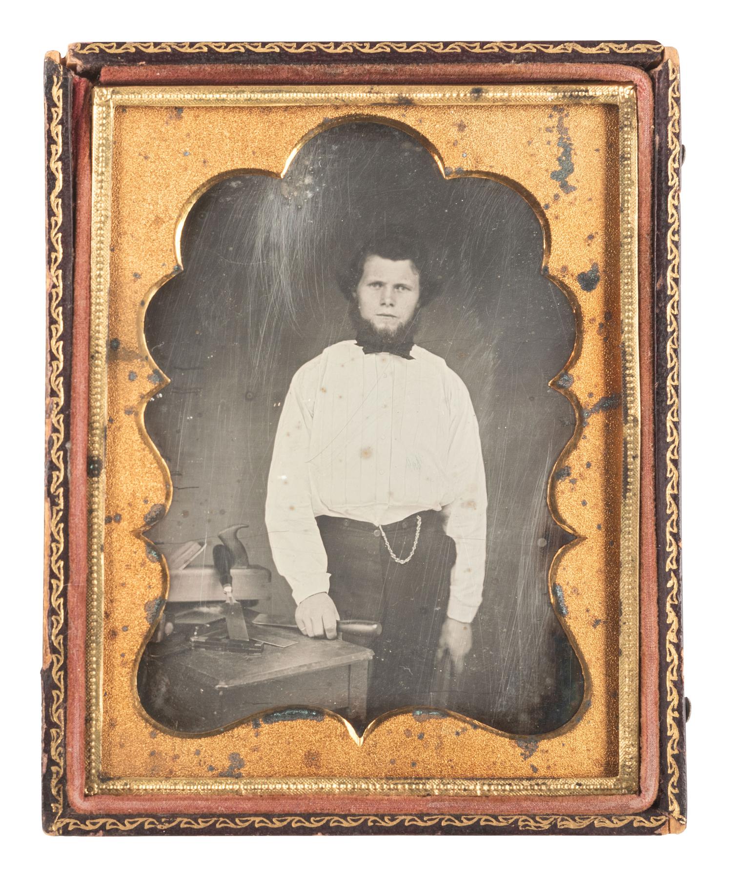 [EARLY PHOTOGRAPHY]. Quarter plate daguerreotype featuring a young carpenter posed with a wood plane and many chisels.