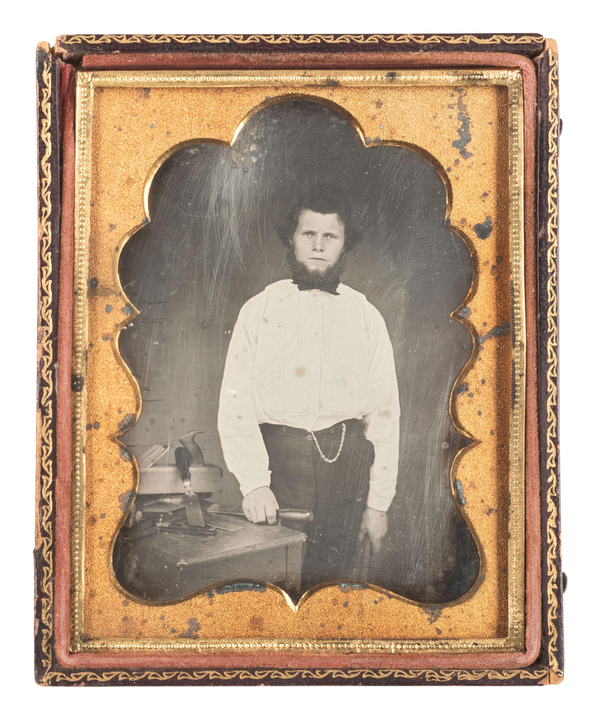 [EARLY PHOTOGRAPHY]. Quarter plate daguerreotype featuring a young carpenter posed with a wood plane and many chisels.