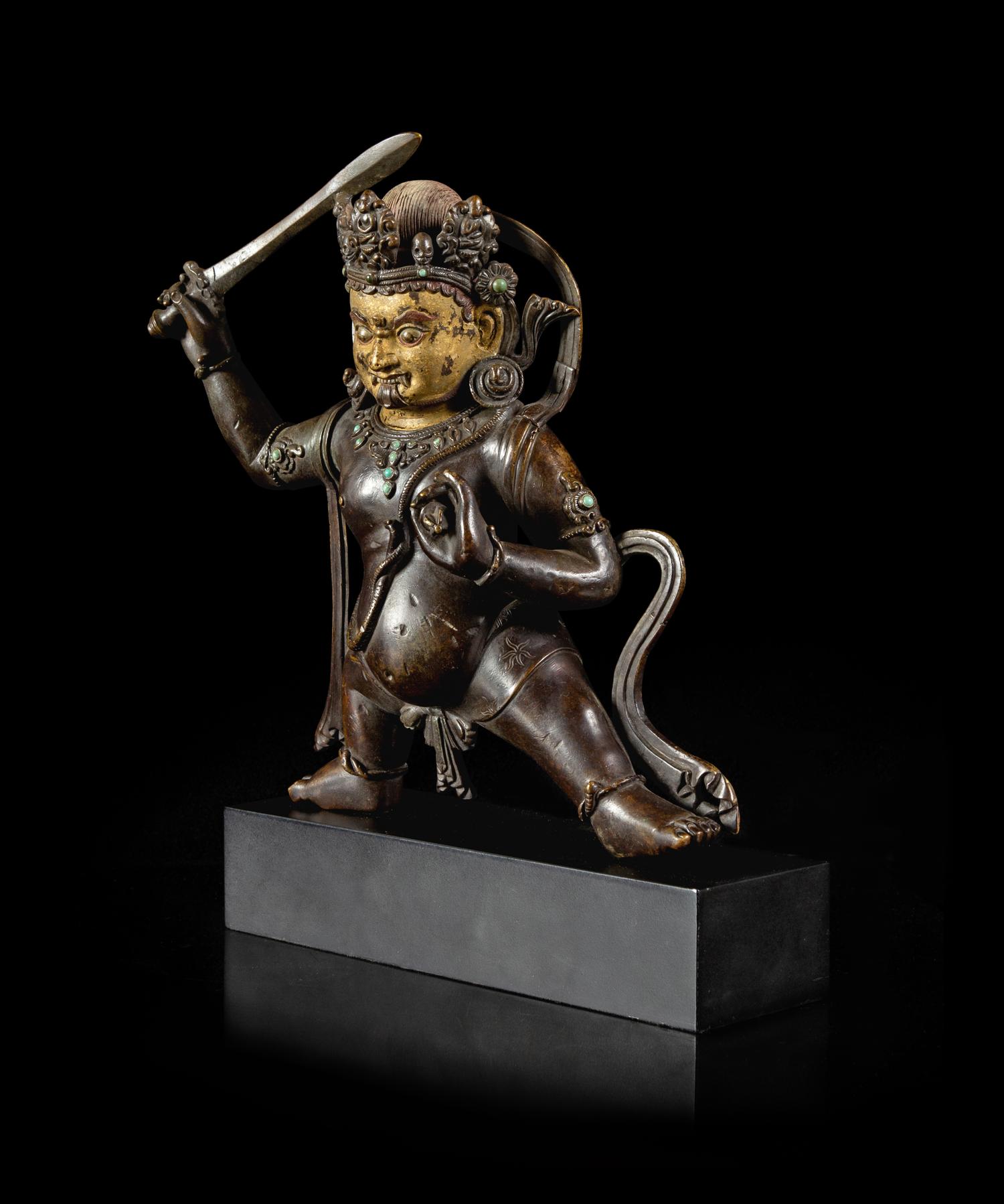 A Sino-Tibetan Parcel-Gilt Bronze Figure of Jambhala