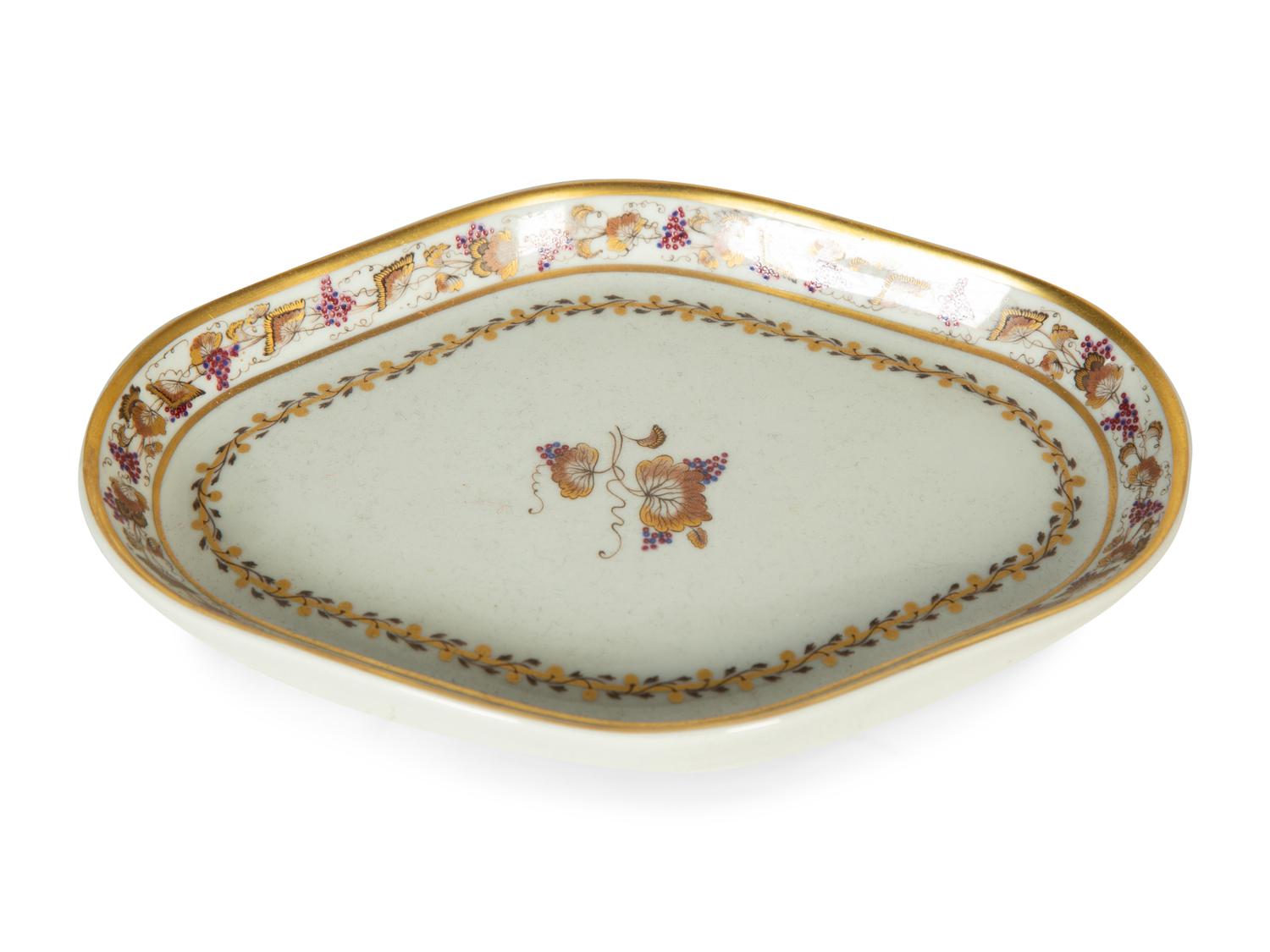 A Mottahedeh Porcelain Tureen, Underplate, and Spoon Rest