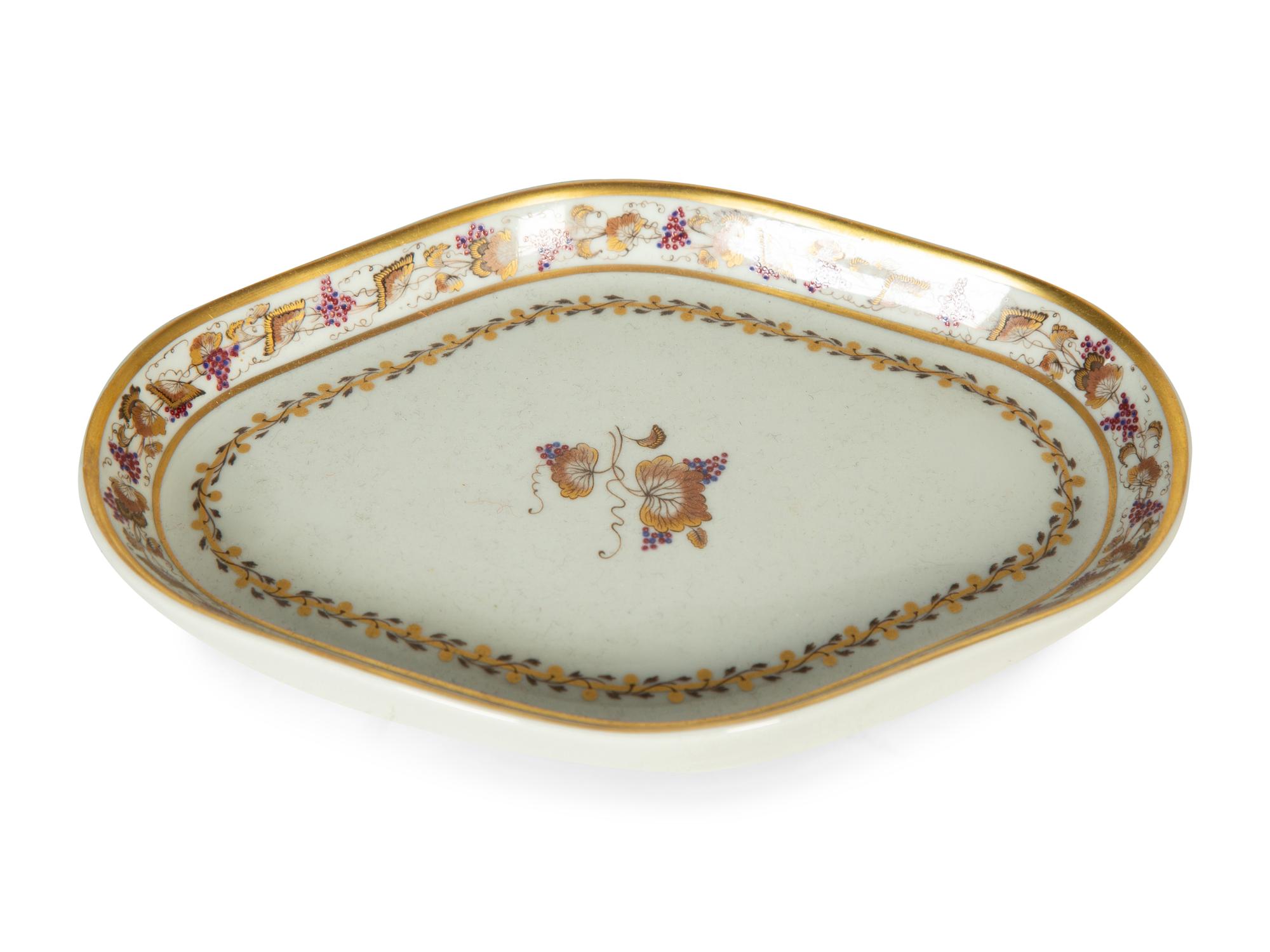 A Mottahedeh Porcelain Tureen, Underplate, and Spoon Rest