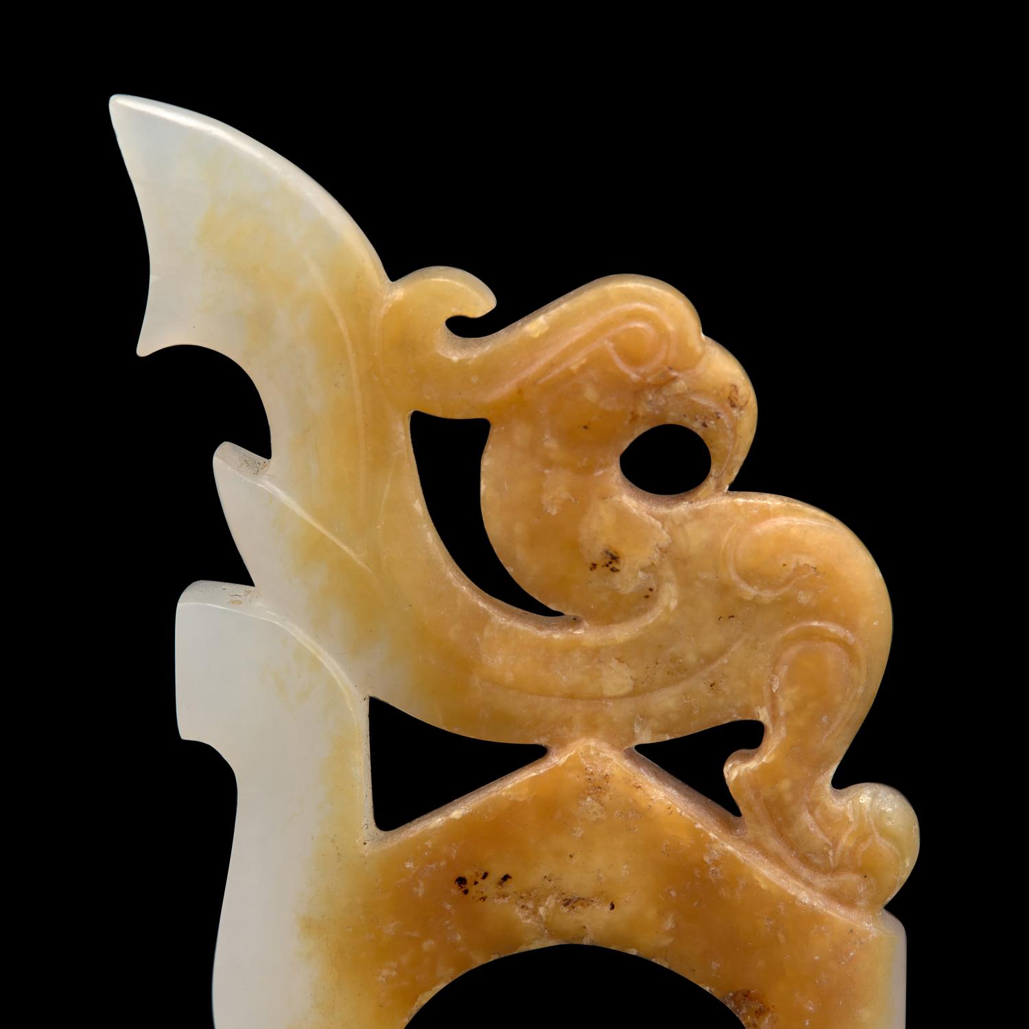 A Chinese Archaistic White and Russet Jade Ring-Form Pendant 白玉鳳紋韘形佩