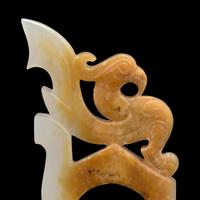 A Chinese Archaistic White and Russet Jade Ring-Form Pendant 白玉鳳紋韘形佩