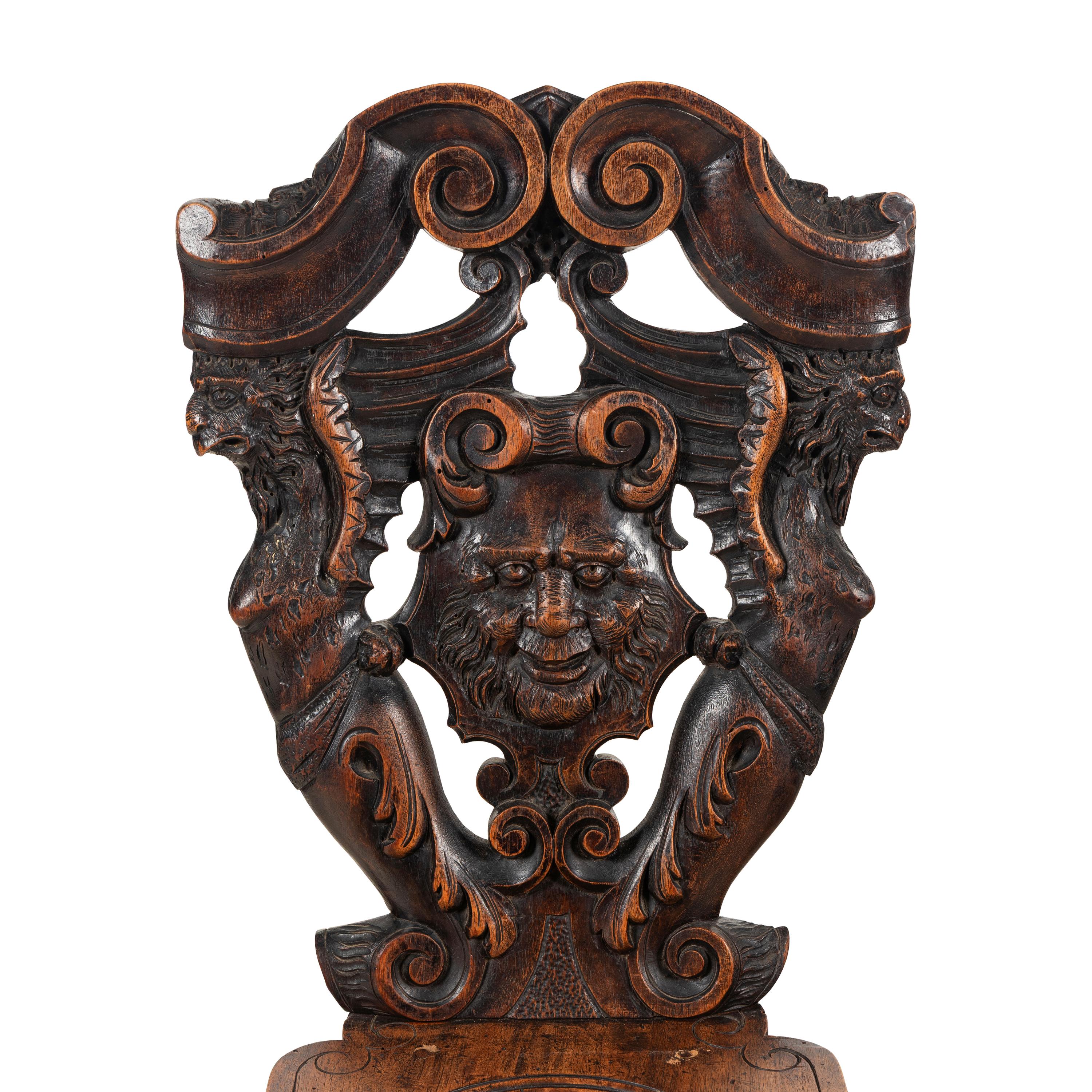 A Pair of Italian Carved Walnut Sgabello Chairs