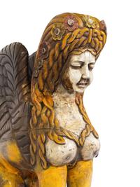 A Large Carved and Polychrome Decorated Wood Sphinx