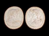 A Pair of Italian Neoclassical Style Iron-Mounted Marble Portrait Reliefs of a Caesar