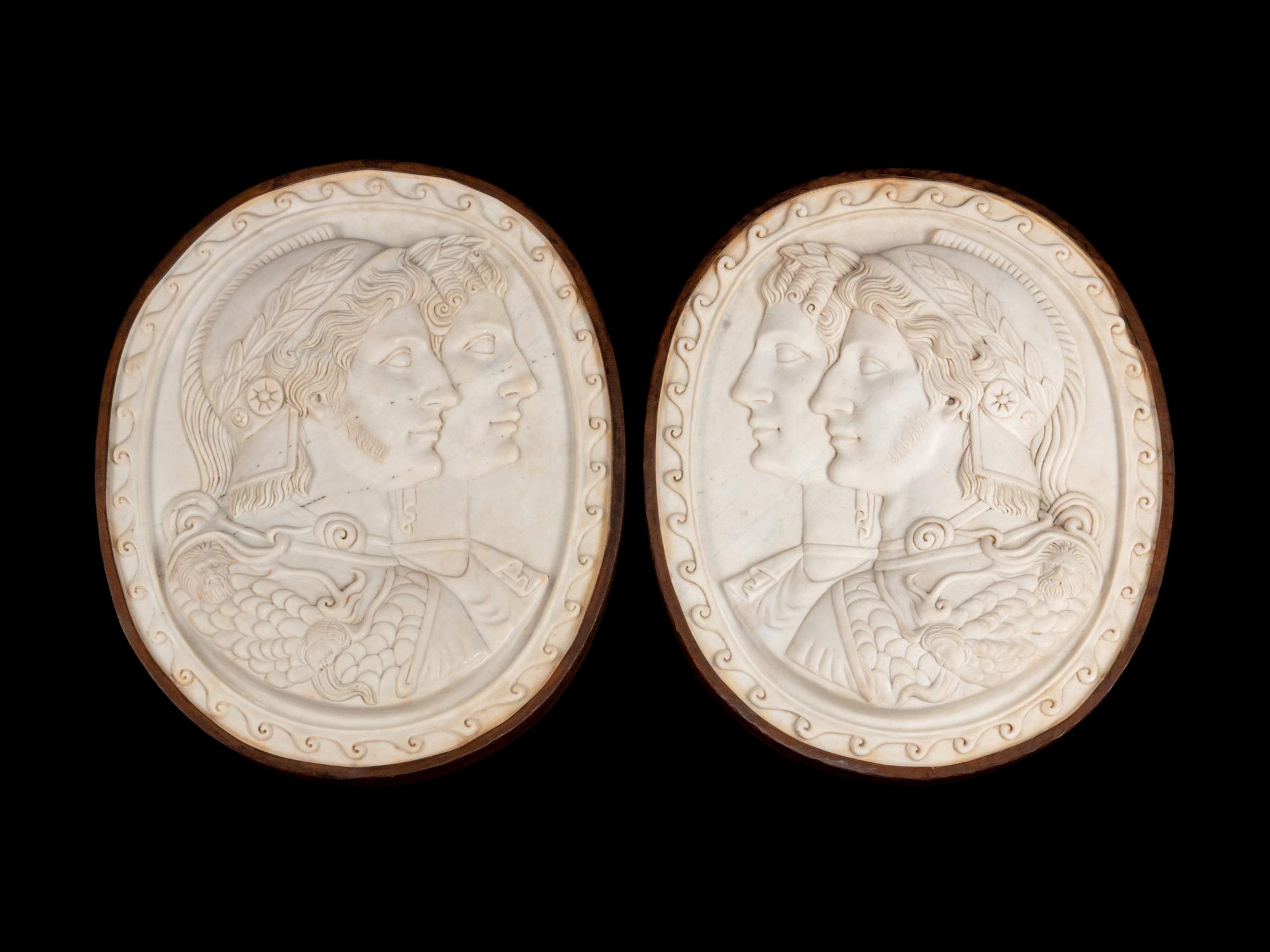 A Pair of Italian Neoclassical Style Iron-Mounted Marble Portrait Reliefs of a Caesar