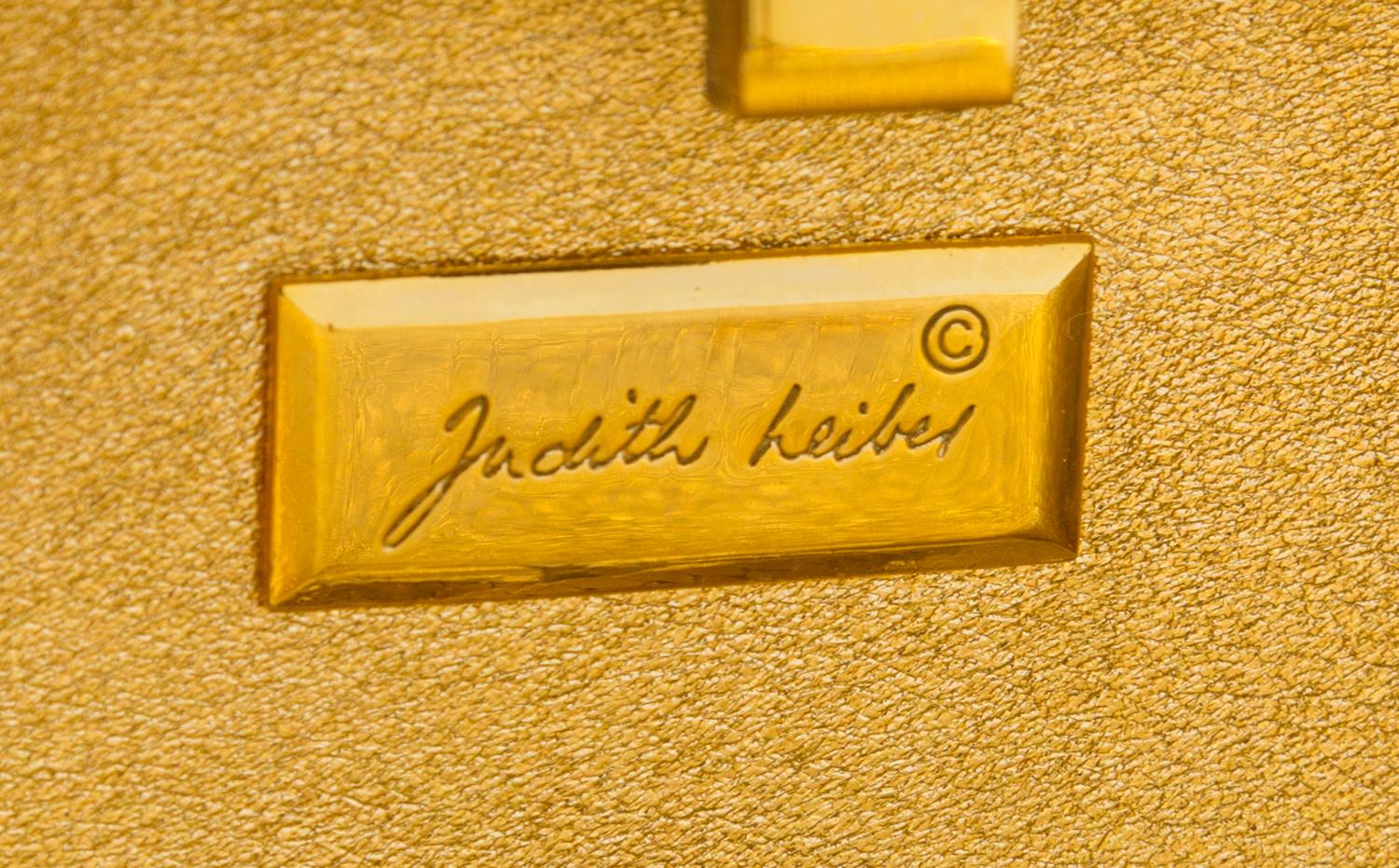 A Judith Leiber Black Floral Minaudiere, 3.75"H x 5"W x 1"D; Strap drop: 19.5".