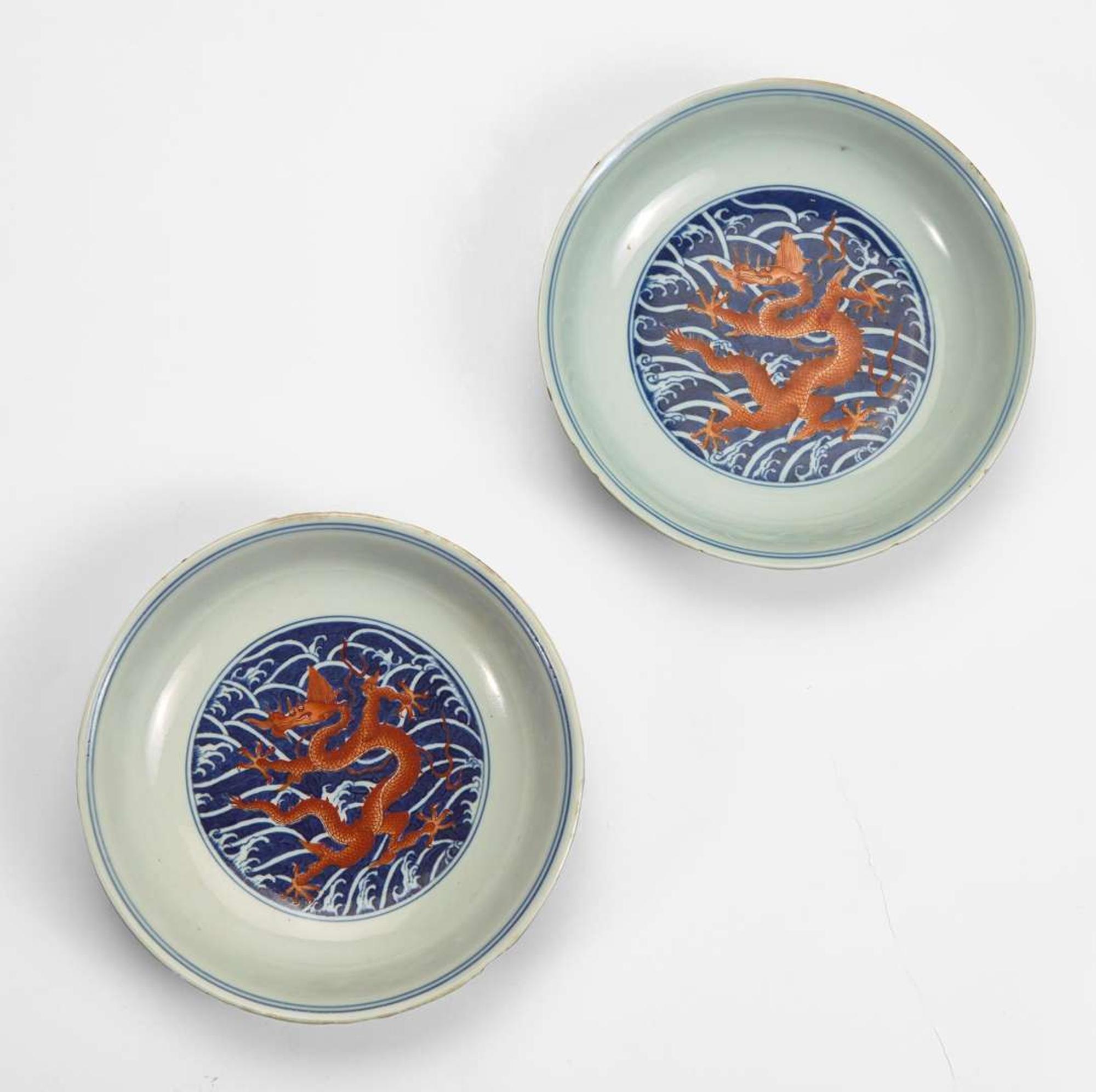 An associated pair of iron-red and underglaze blue "Dragon" Dishes 礬红青花龙纹盘子 或为一对 Qianlong six-character seal mark and of the period ????? ? ??