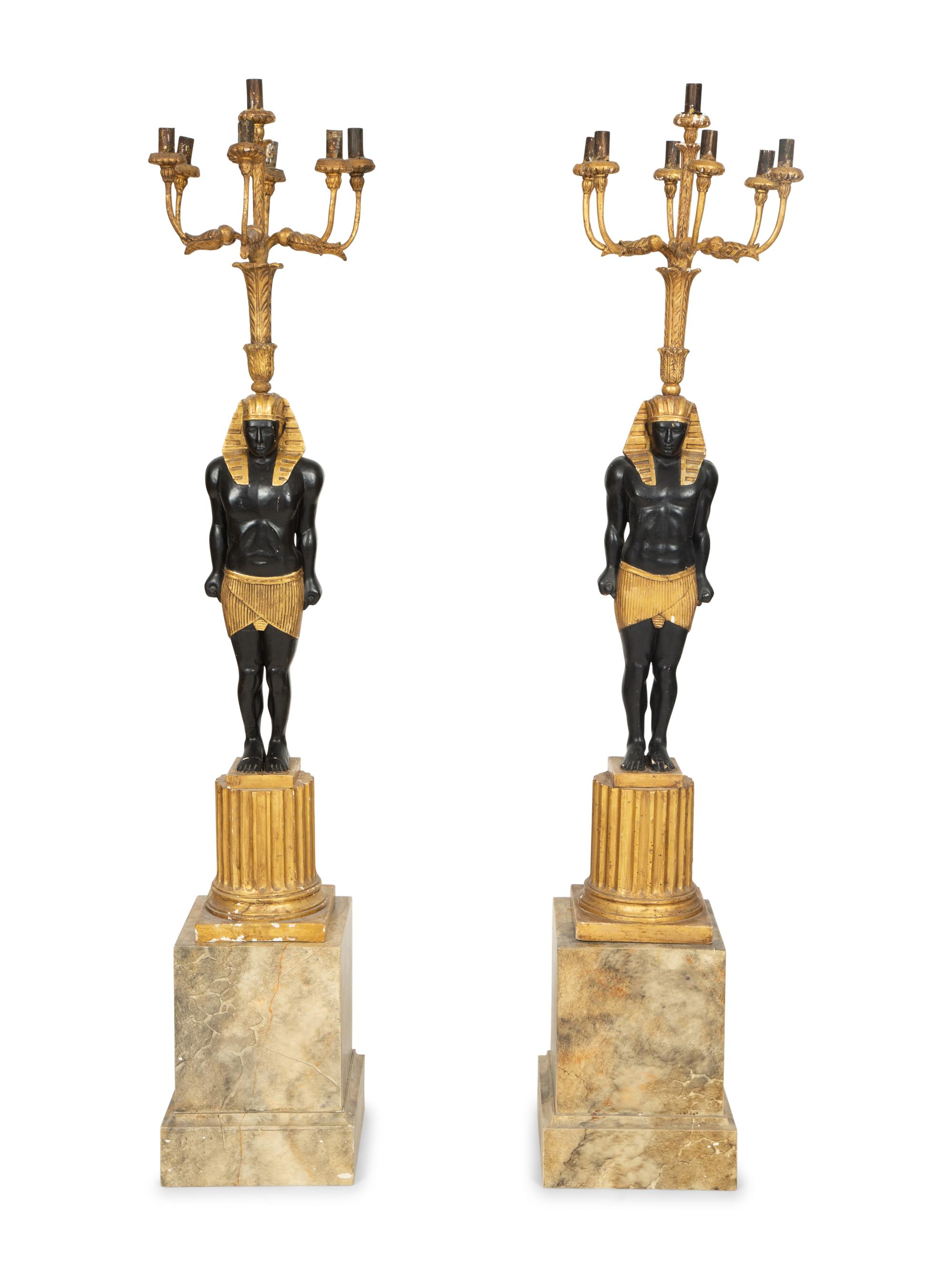 A Pair of Egyptian Revival Ebonized and Giltwood Figural Torchères