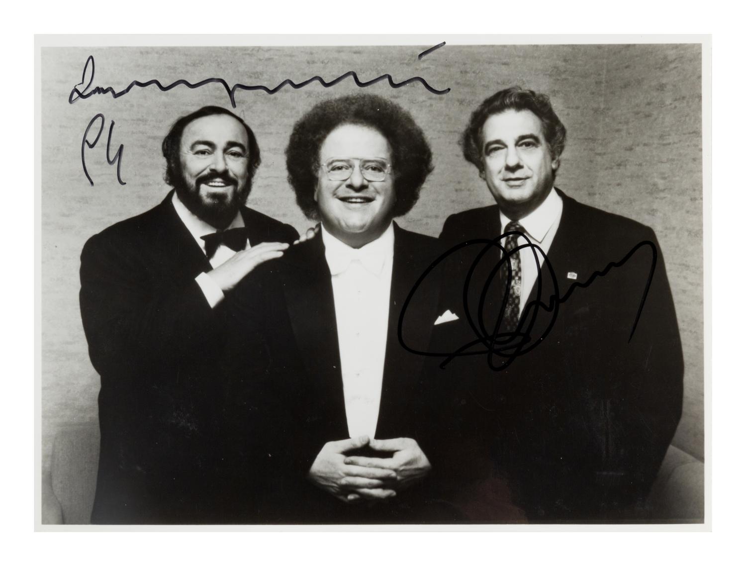 PAVAROTTI, Luciano (1935-2007) -- DOMINGO, Plácido (b. 1941). Black and white photograph, signed (“Luciano Pavarotti” and “Plácido Domingo”), 1994.