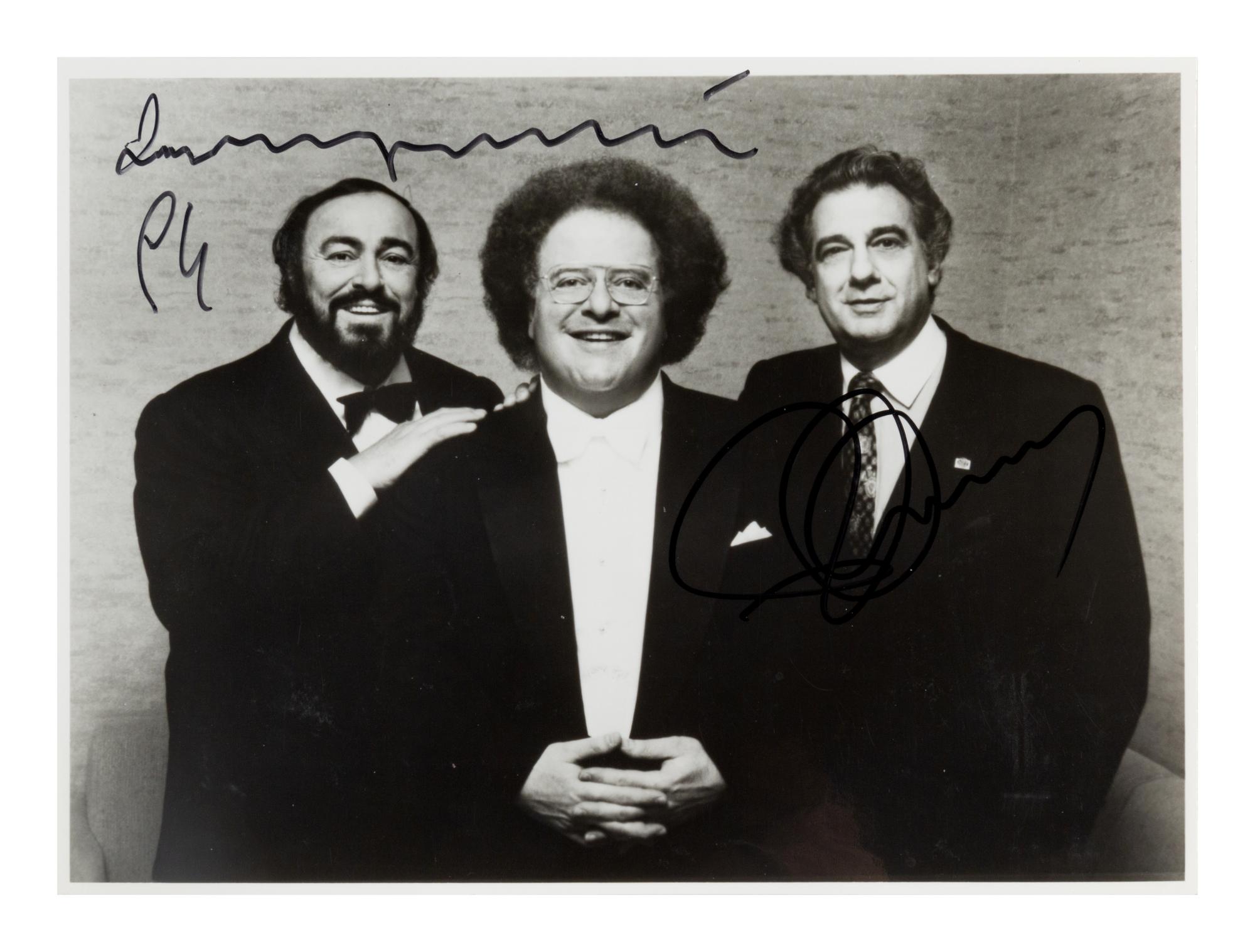 PAVAROTTI, Luciano (1935-2007) -- DOMINGO, Plácido (b. 1941). Black and white photograph, signed (“Luciano Pavarotti” and “Plácido Domingo”), 1994.