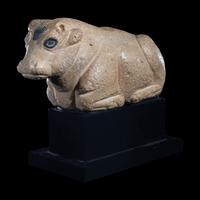 A Mesopotamian Limestone Recumbent Bull with Lapis Lazuli Inlays