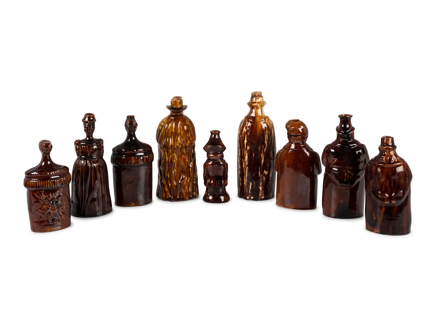 Nine Figural Flasks in Brown Glaze