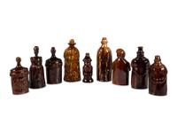 Nine Figural Flasks in Brown Glaze
