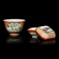 Two Chinese Faux-Bois and Famille Rose Porcelain Wares, Late 19th-Early 20th Century — 晚清-民國 粉彩仿木紋開光山水圖八方小蓋盒及茶杯