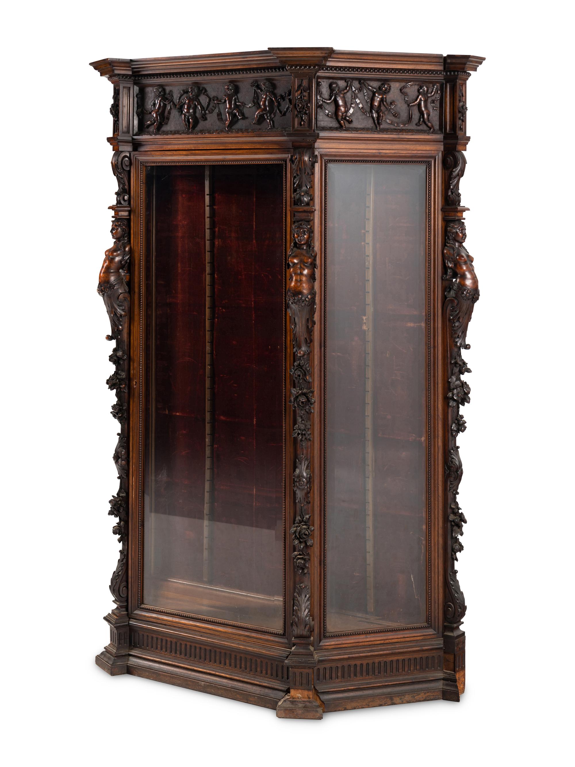 An Italian Renaissance Revival Carved Walnut Cabinet