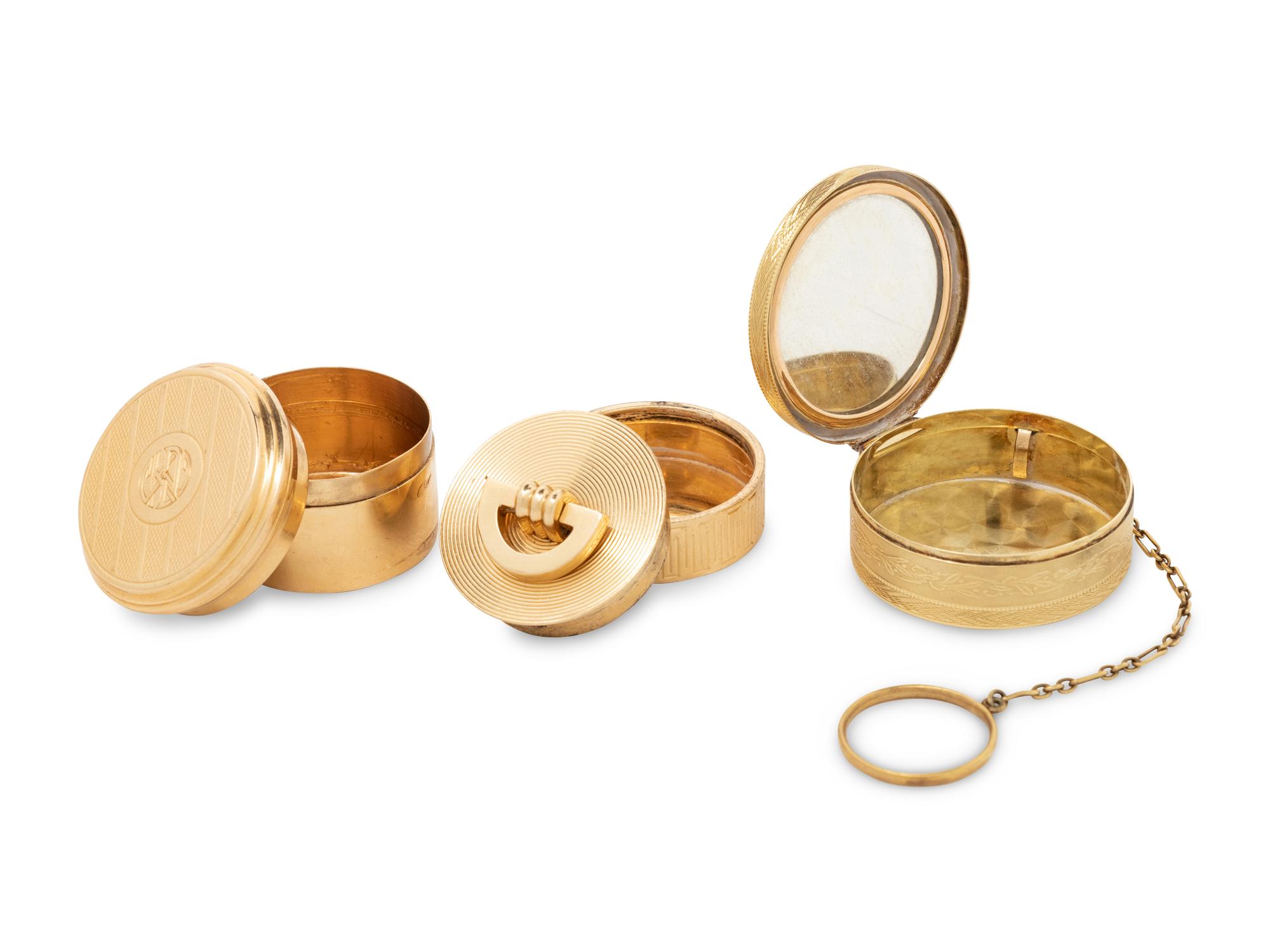 Two Cartier Gold Pill Boxes and Another Gold Pill Box