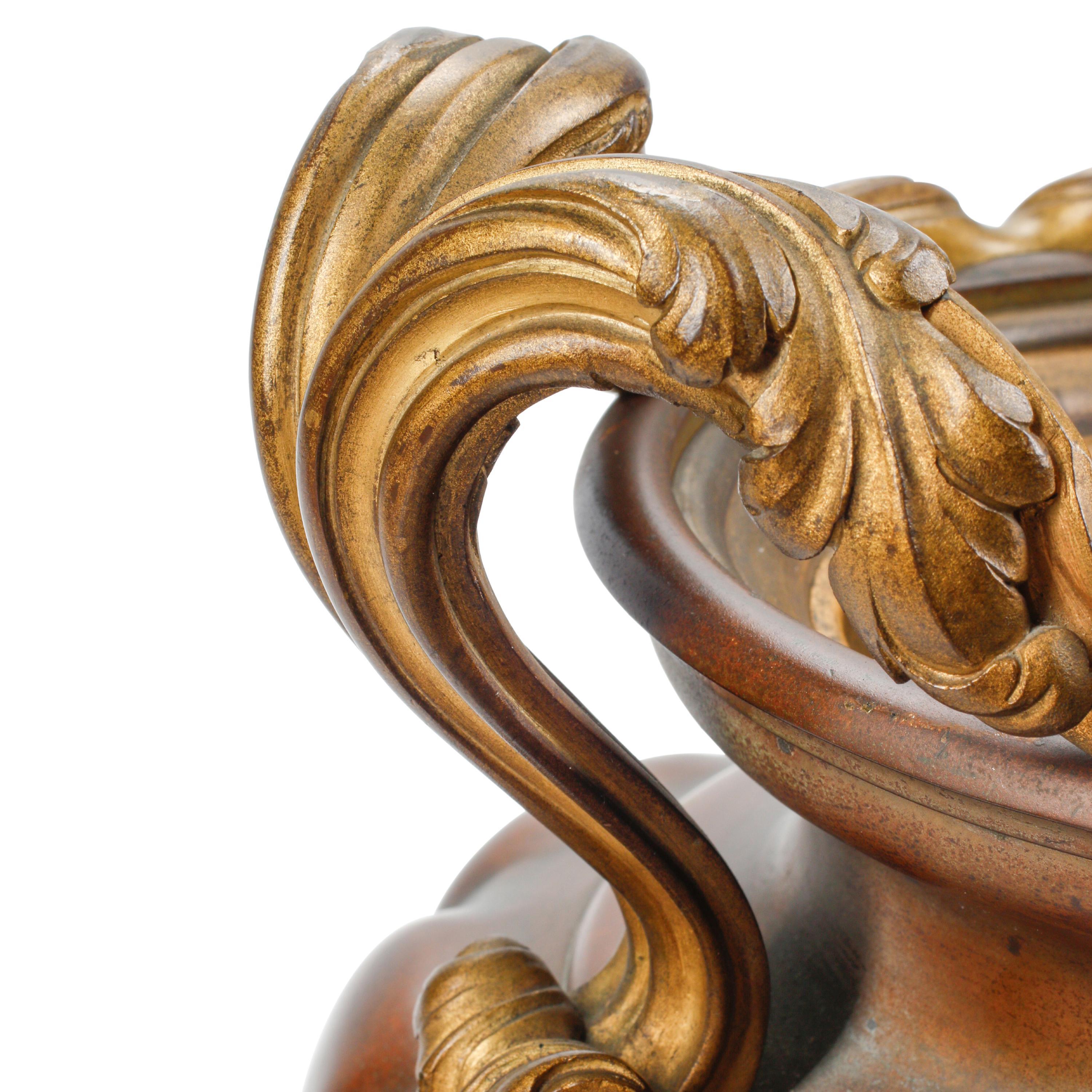 A Pair of French Patinated and Parcel Gilt Bronze Urns