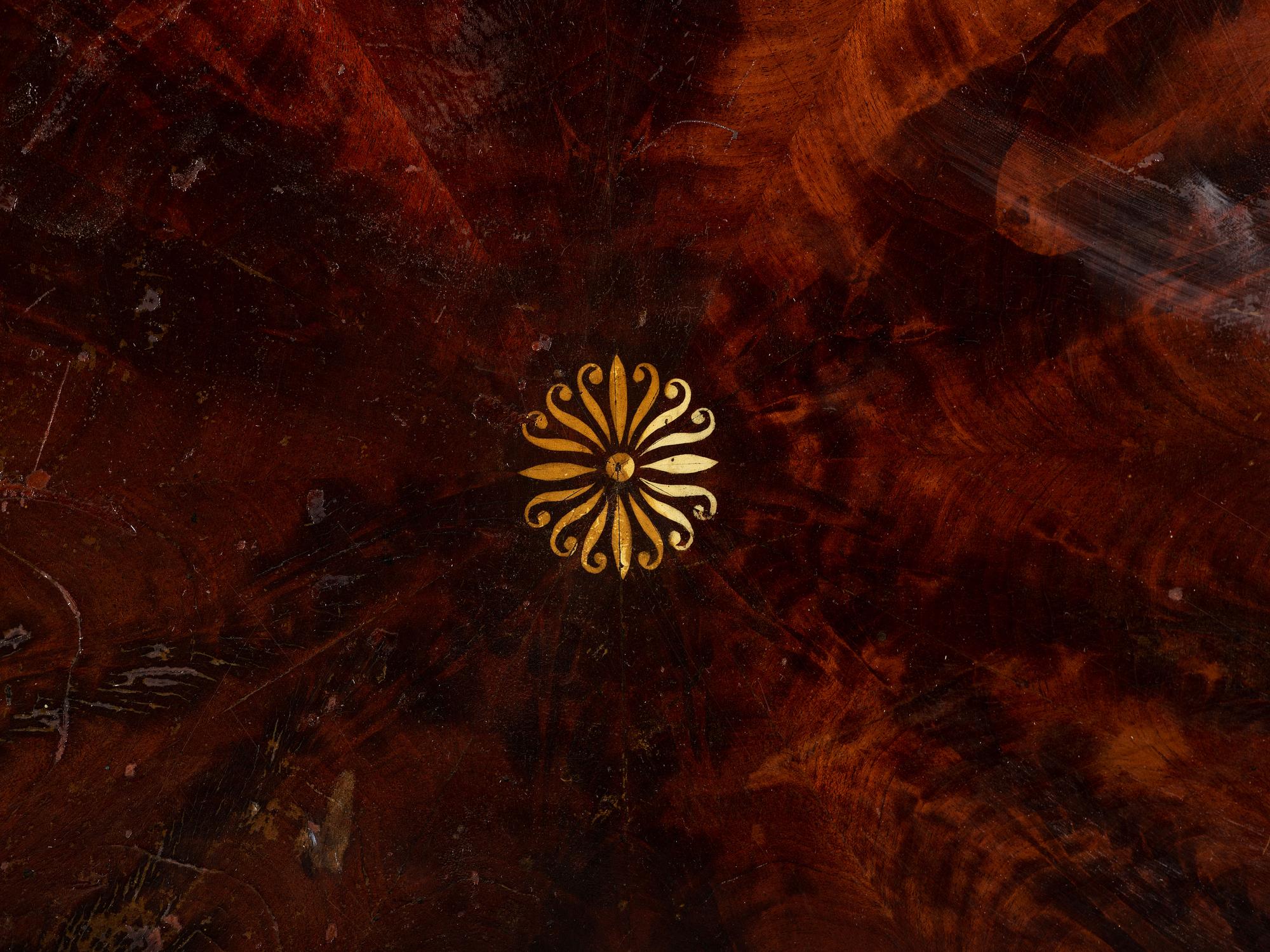 A Classical Parcel Gilt, Stencil Decorated, Carved and Inlaid Mahogany Tilt-Top Claw-Foot Breakfast Table