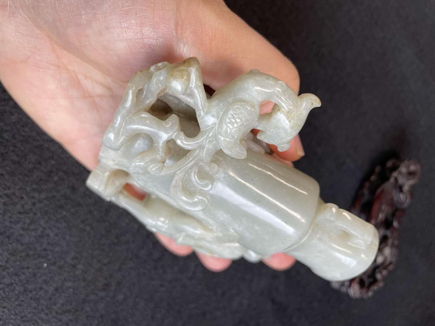 A Chinese jade "Boys, Kylin and Phoenix" vase on carved wood stand 玉雕童子凤鸟花樽及底座