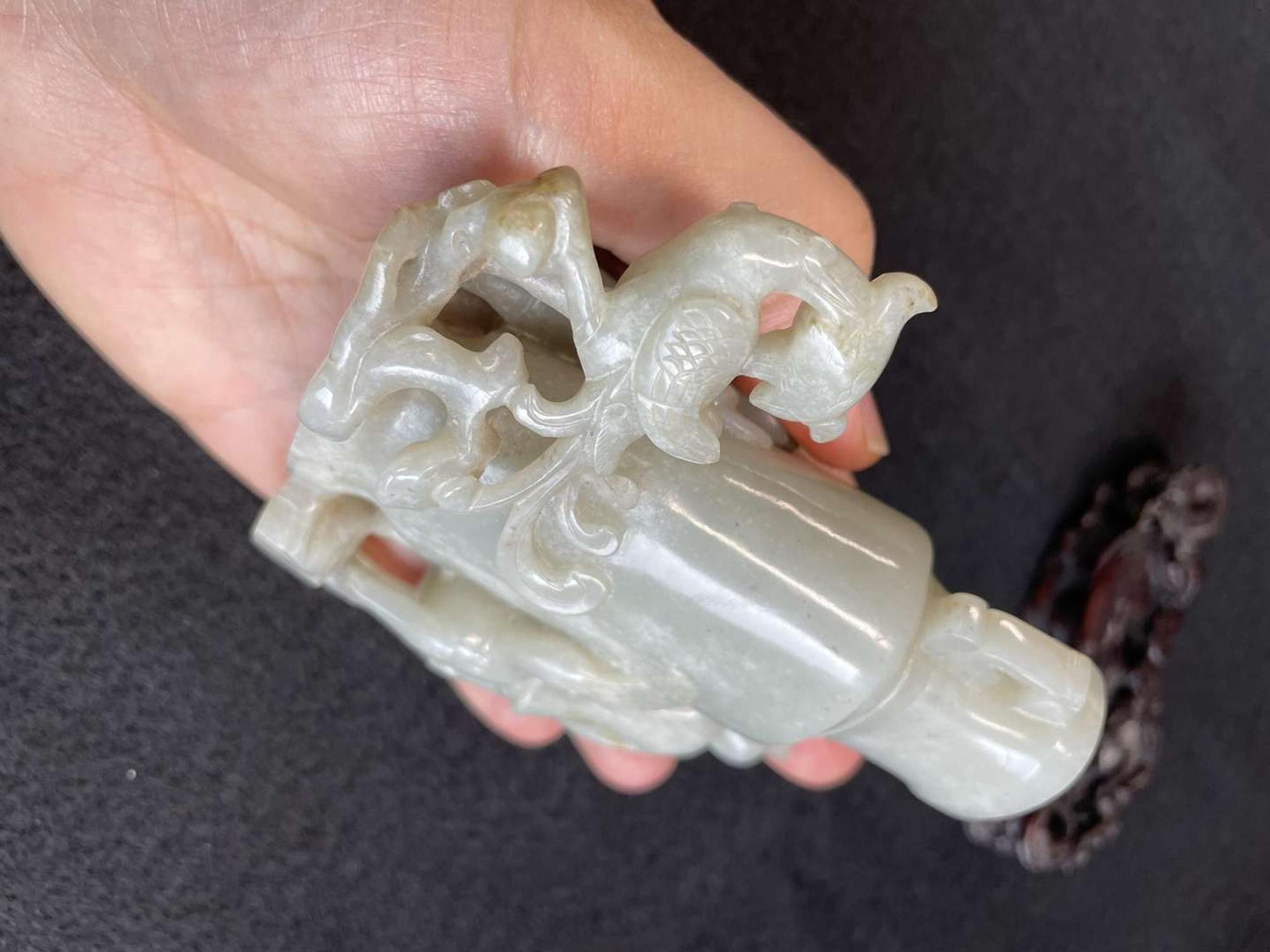 A Chinese jade "Boys, Kylin and Phoenix" vase on carved wood stand 玉雕童子凤鸟花樽及底座