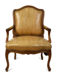 A French Provincial Style Leather Upholstered Fauteuil — 19TH CENTURY