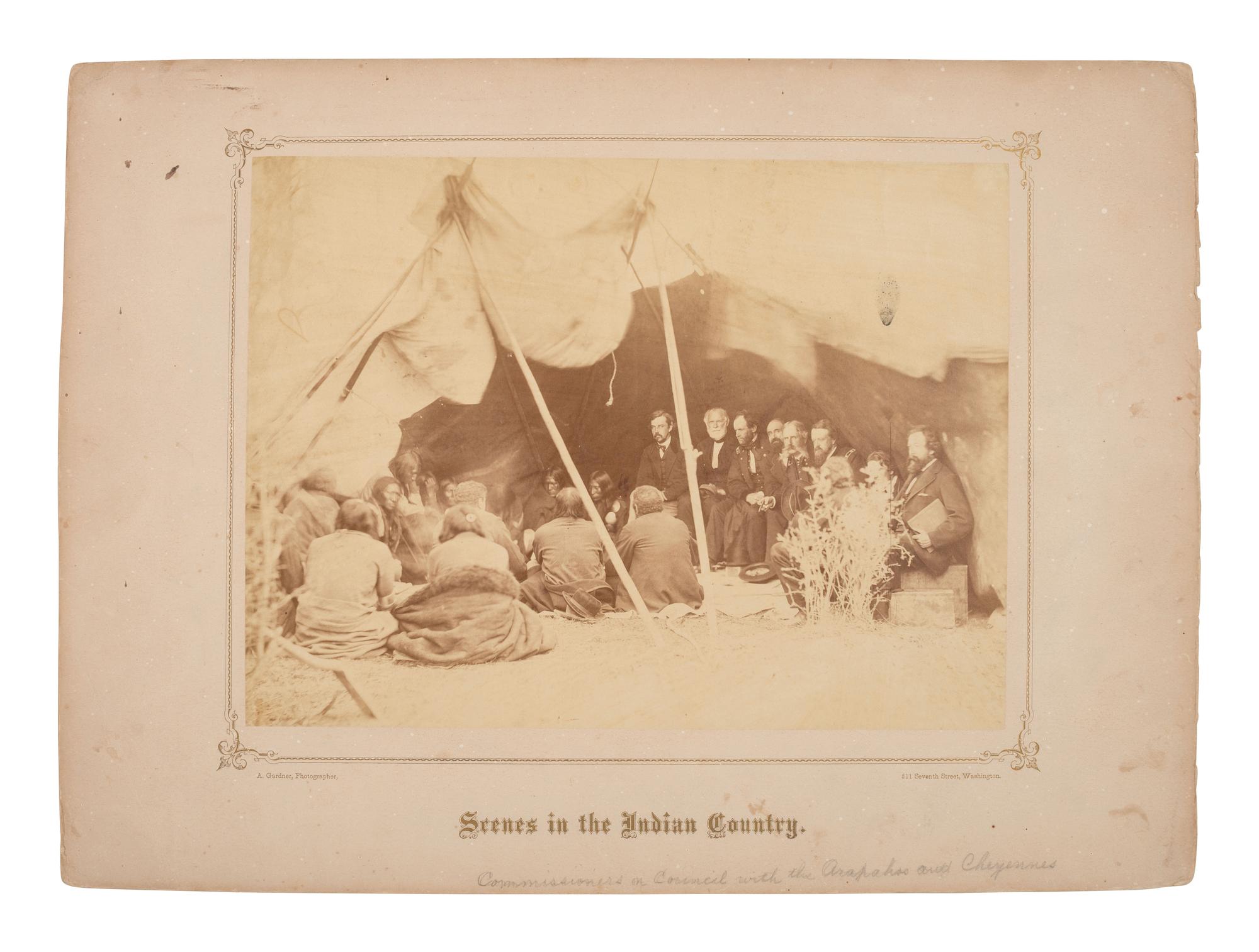GARDNER, Alexander (1821-1882), photographer. Albumen photograph of council meeting at Fort Laramie, showing multiple commissioners with Arapaho and Cheyenne leaders. May 1868.