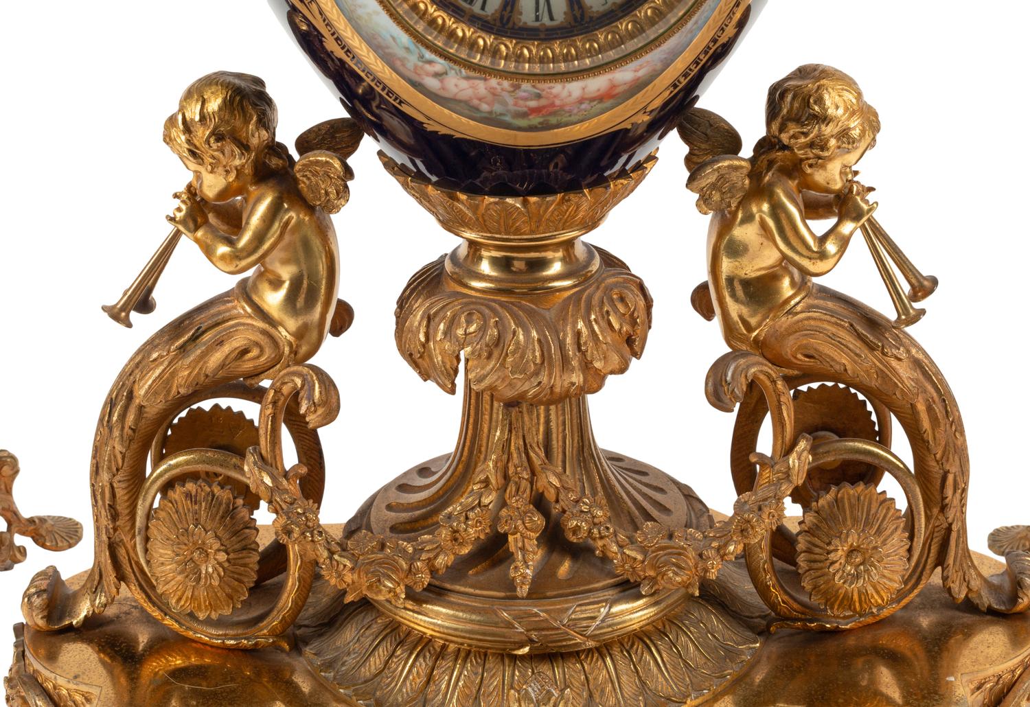 A Louis XVI Style Gilt Bronze and Sèvres Style Porcelain Clock Garniture