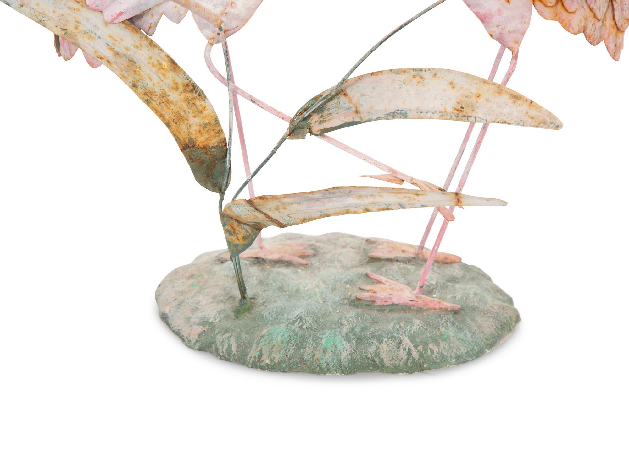 A Tole Peint Model of Two Flamingos and a Glazed Earthenware Model of a Flamingo