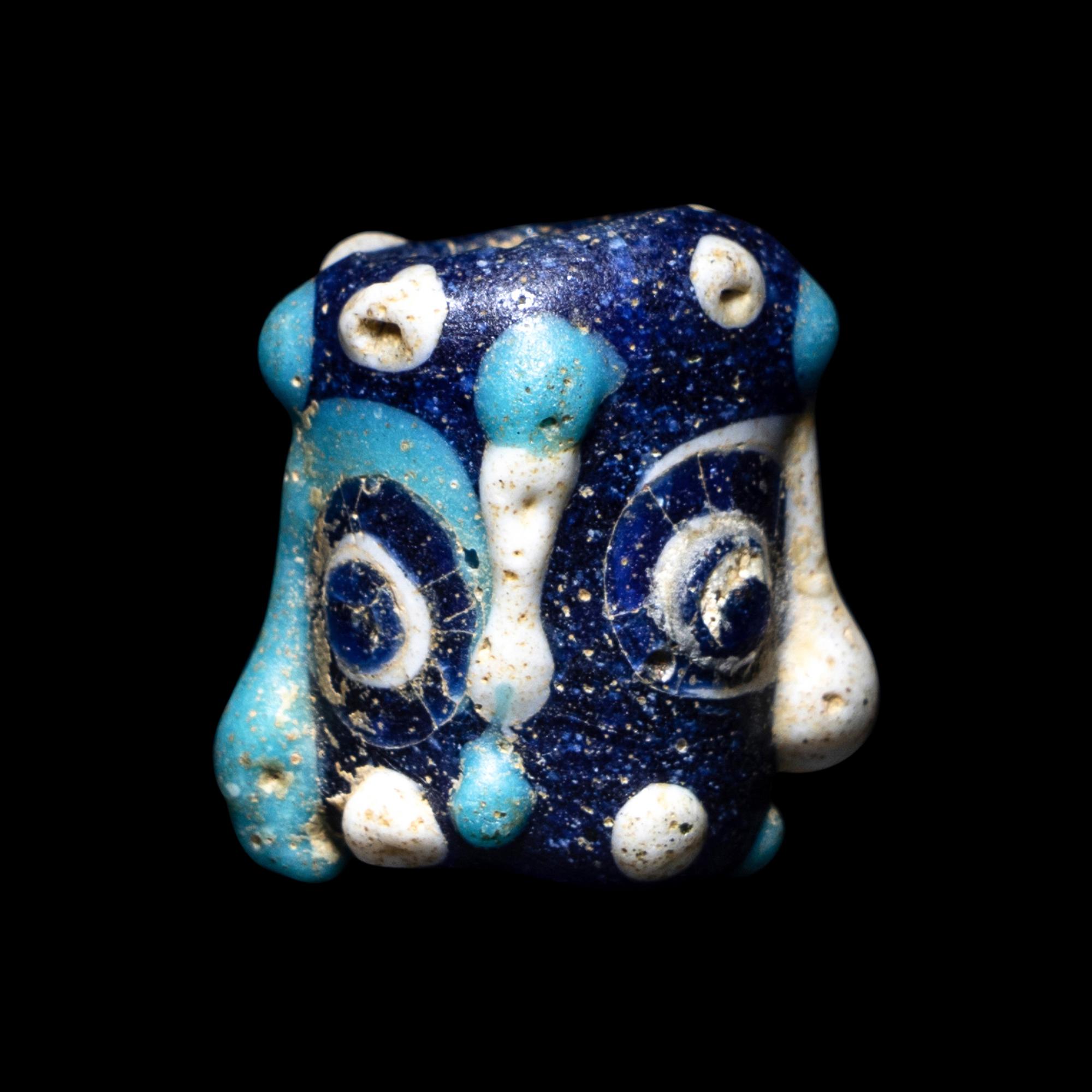 A Phoenician Glass Double-Face Bead