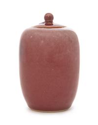 A Small Peachbloom Glazed Porcelain Covered Jar Height 4 7/8 inches.