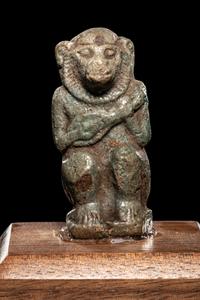 An Egyptian Faience Baboon with Musical Instrument