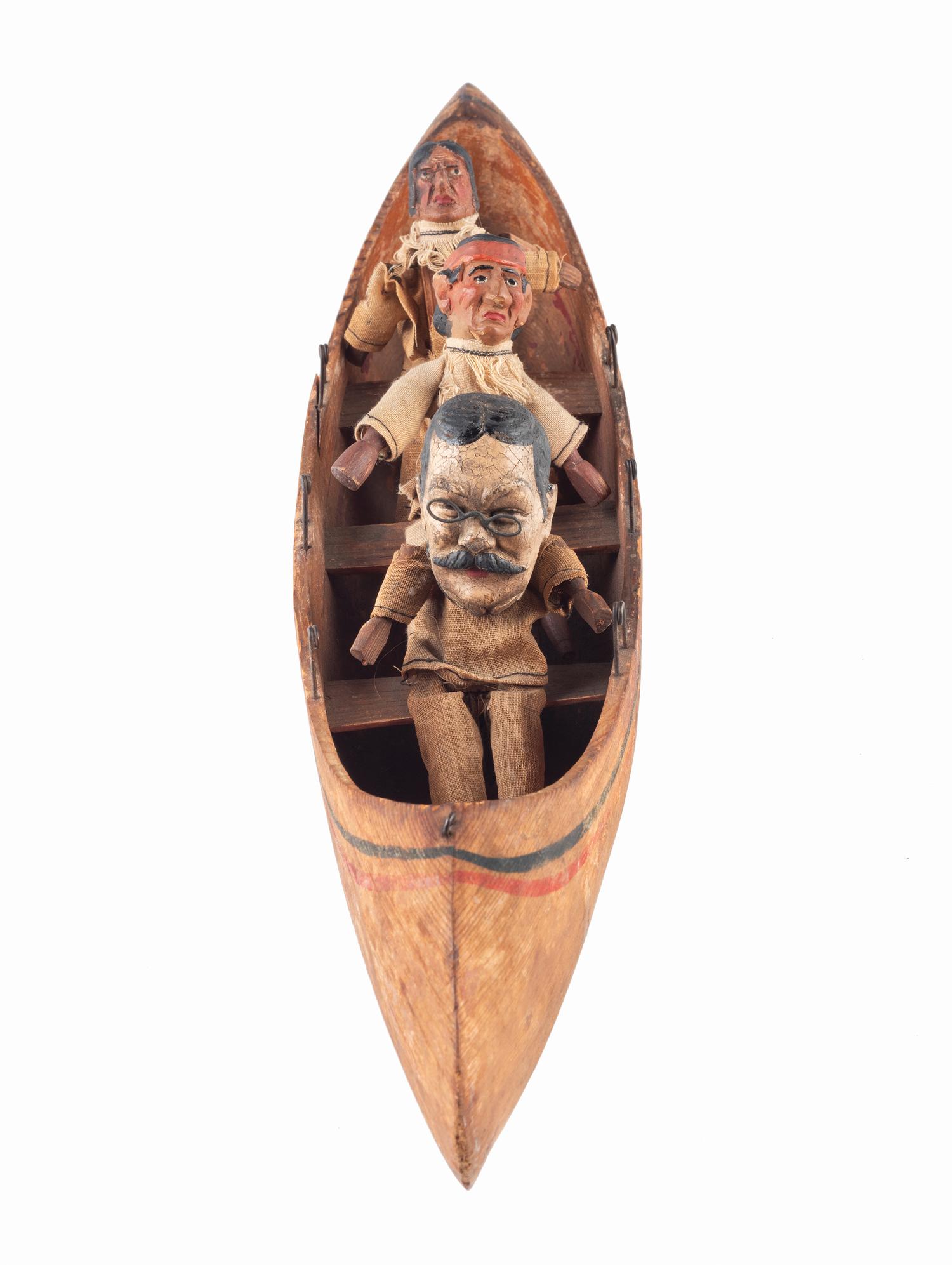 [ROOSEVELT, Theodore (1858-1919)]. Folk art canoe and figures representing Theodore Roosevelt's exploration of the River of Doubt during his expedition to Brazil in 1913-1914.