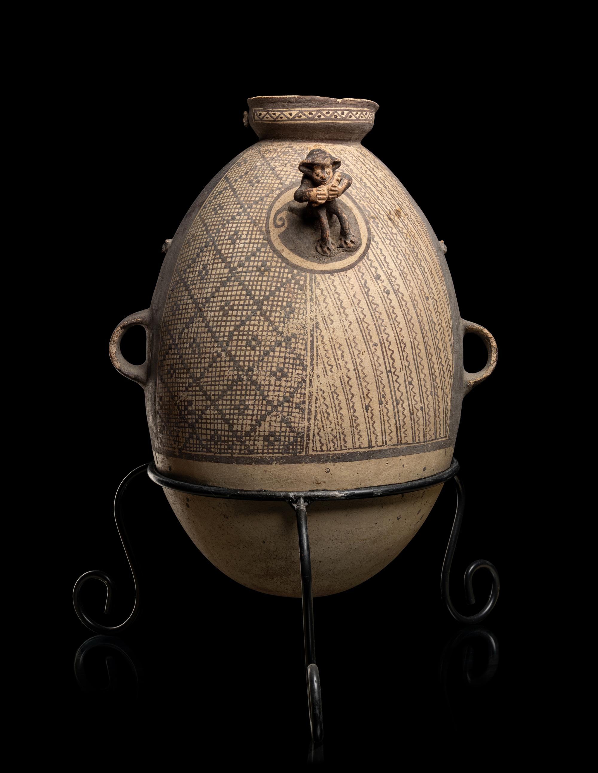 A Chancay Bichrome Vessel with Monkey Figure