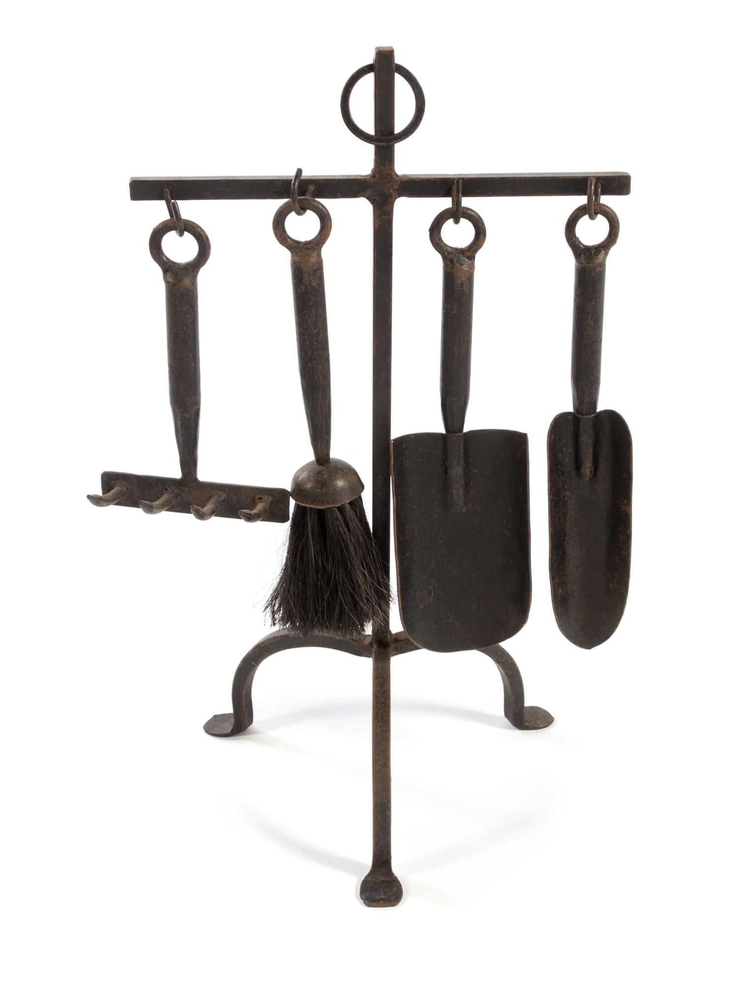 A Set of Wrought Iron Fire Tools Height of stand 20 inches.