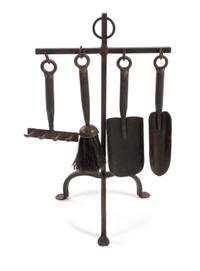 A Set of Wrought Iron Fire Tools Height of stand 20 inches.