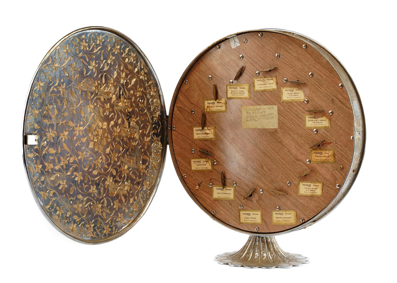 A Fred Zimbalist Twelve-Air Music Box Height 15 3/4; diameter of case 14 1/8 inches.