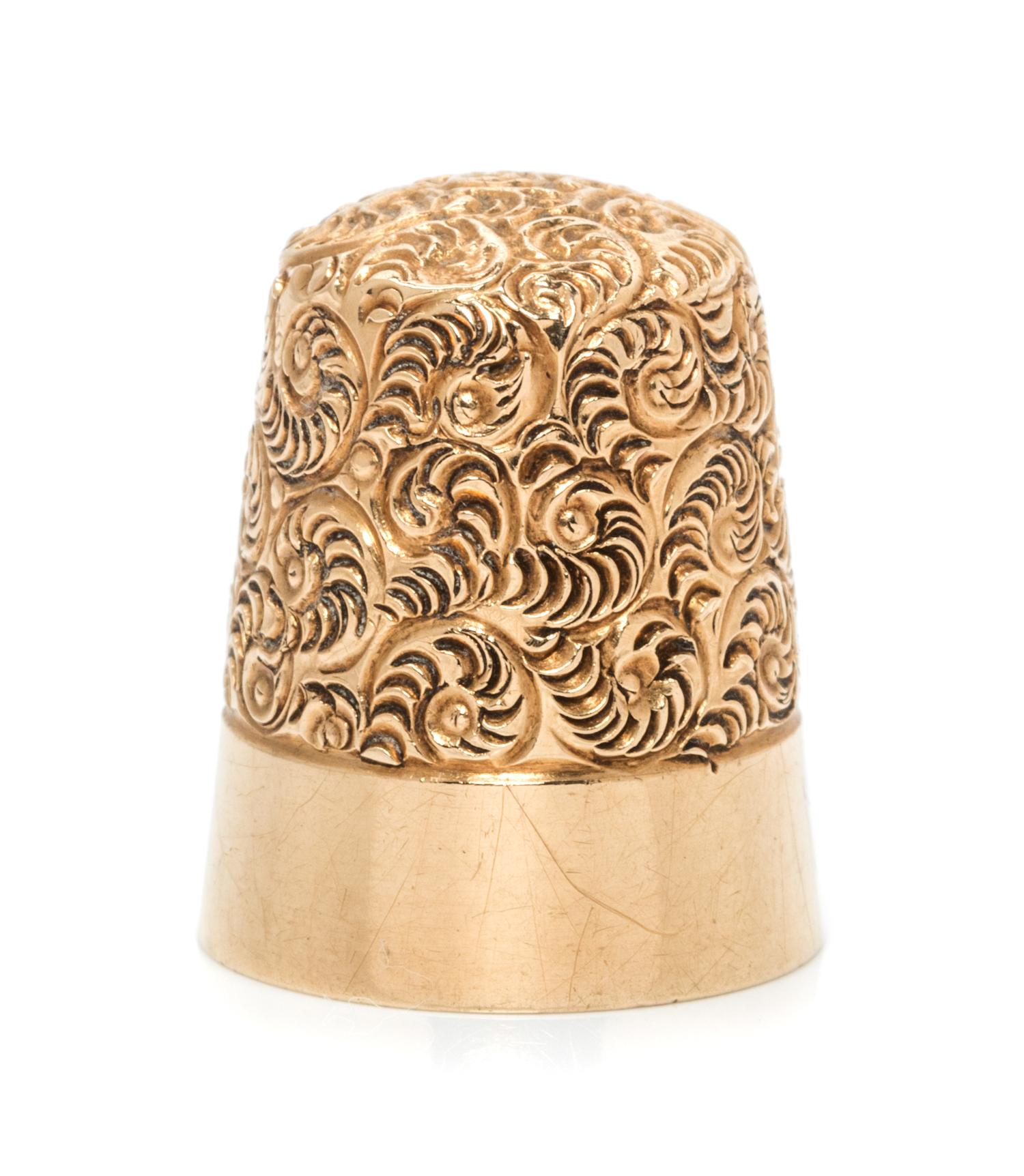 An American 14-Karat Yellow Gold Thimble, Simons Bros., Philadelphia, PA, the top and body worked to show scrolled decoration above a p