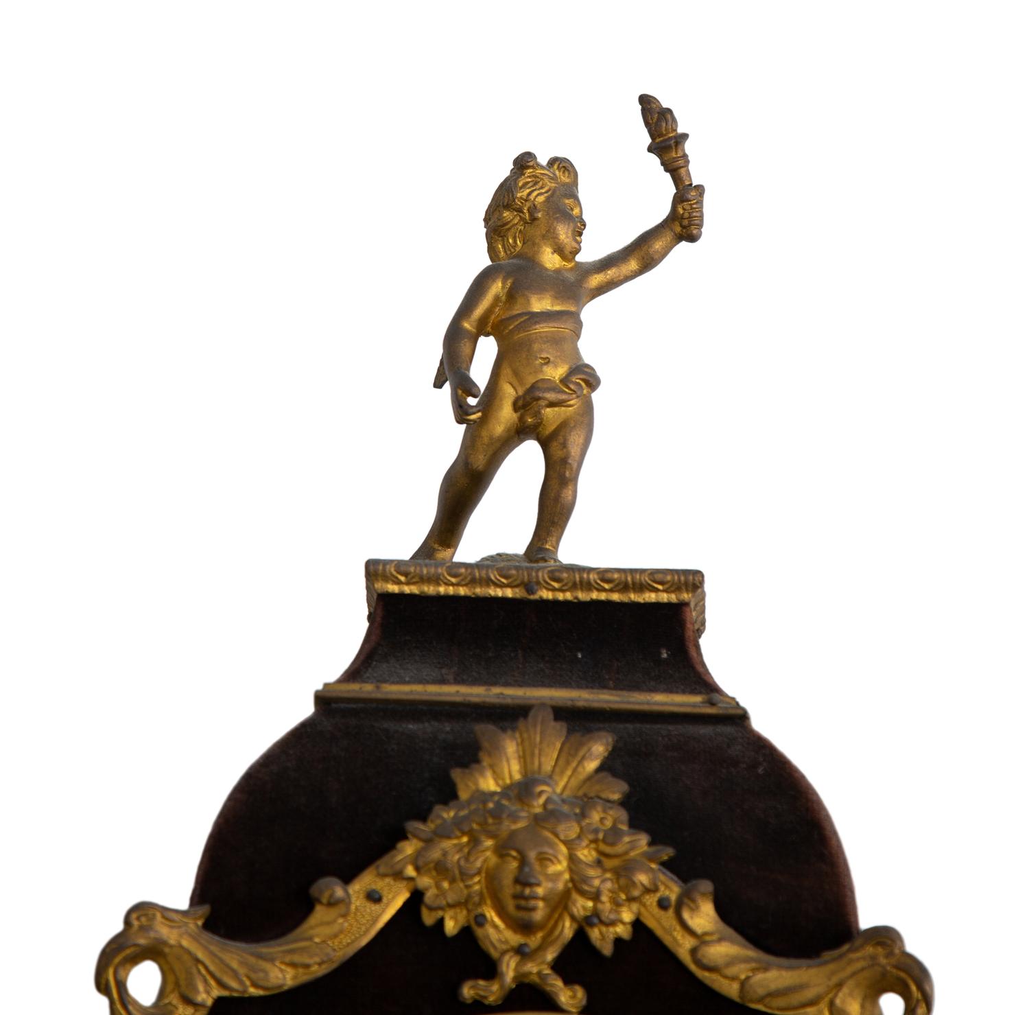 A Louis XV Style Gilt Bronze and Velvet Bracket Clock