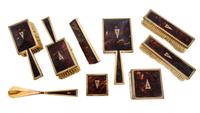 An English 9 Karat Gold Mounted Nine-Piece Dresser Set, Asprey Co., Ltd., London, Early 20th Century, having engine-turned edges, shell