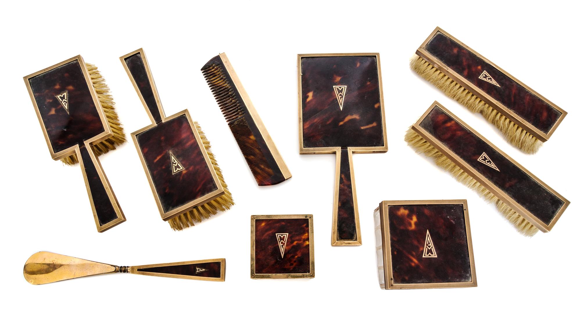 An English 9 Karat Gold Mounted Nine-Piece Dresser Set, Asprey Co., Ltd., London, Early 20th Century, having engine-turned edges, shell