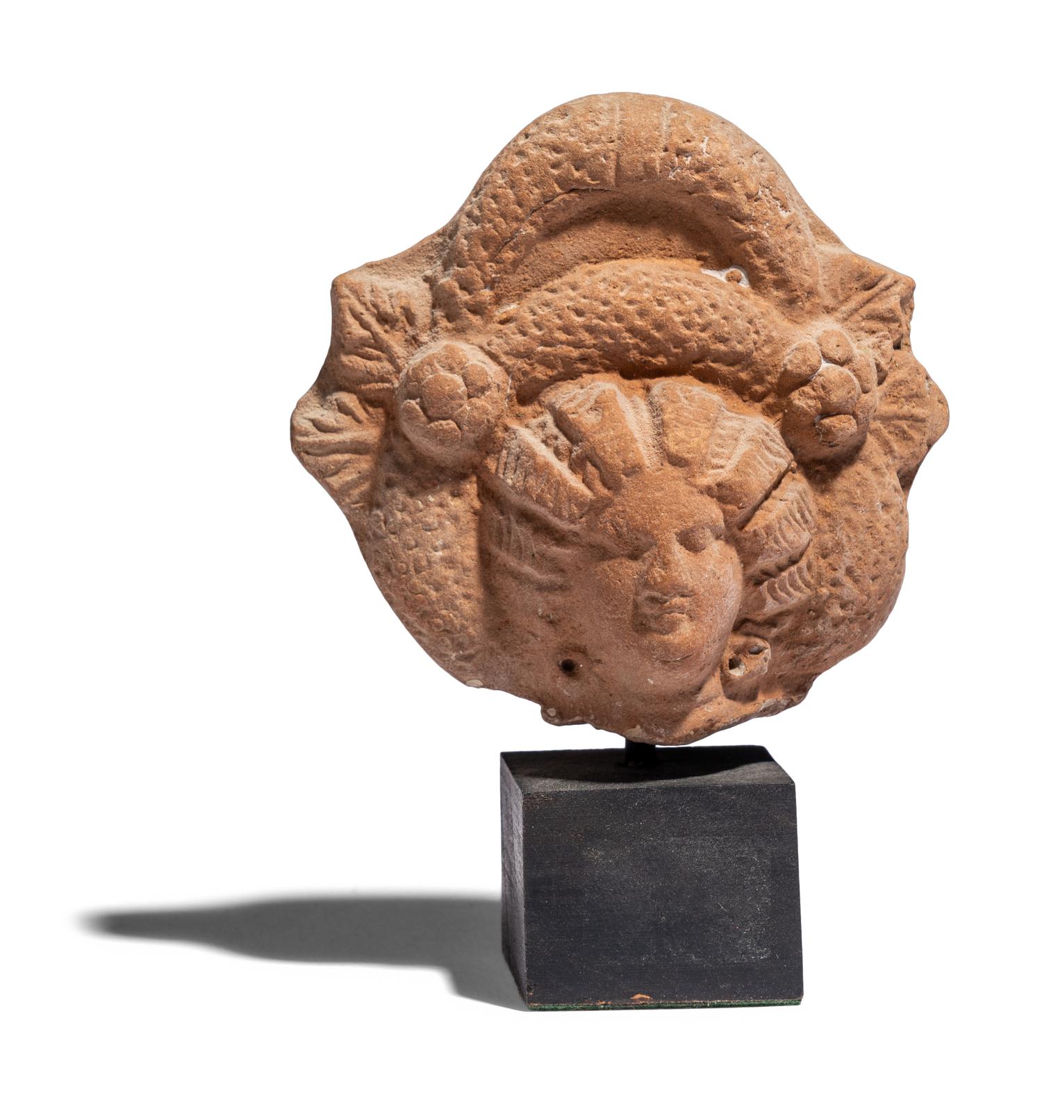 An Egyptian Terracotta Head of a Goddess