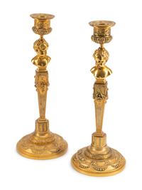 A Pair of Continental Gilt Metal Candlesticks with Busts of Children