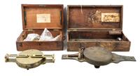 A Group of Two Brass Surveor's Compasses Width of larger example 16 inches.