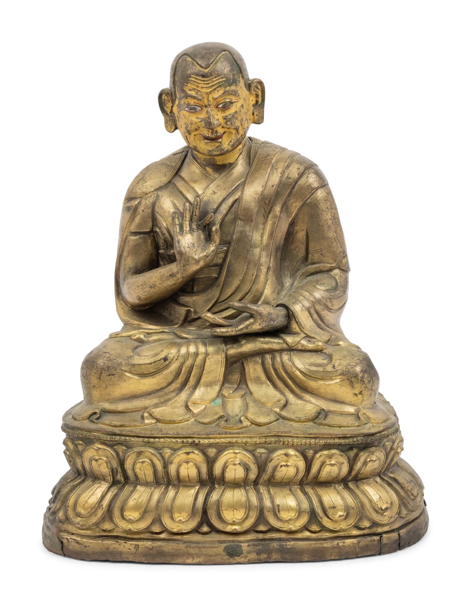 A Large Tibetan Parcel Gilt Bronze Repoussé Figure of a Seated Monk