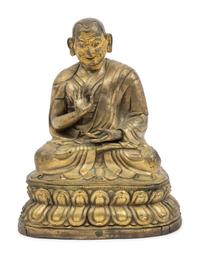 A Large Tibetan Parcel Gilt Bronze Repoussé Figure of a Seated Monk